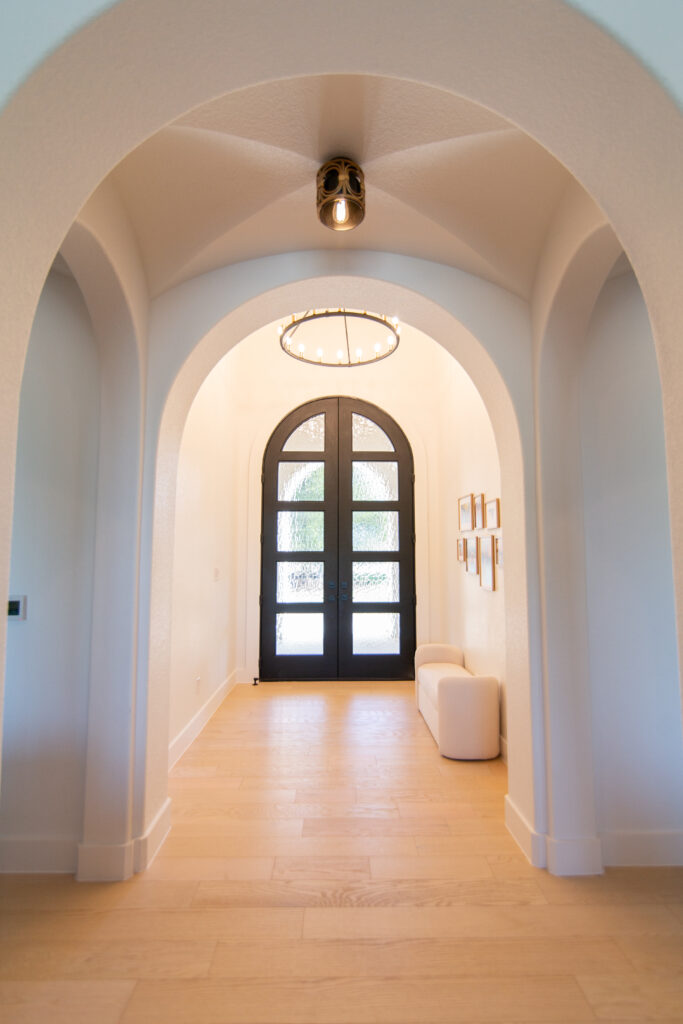 Five Oaks Custom Builders - home renovation with custom design and styling for central texas - arched entryway and front door with drop zone