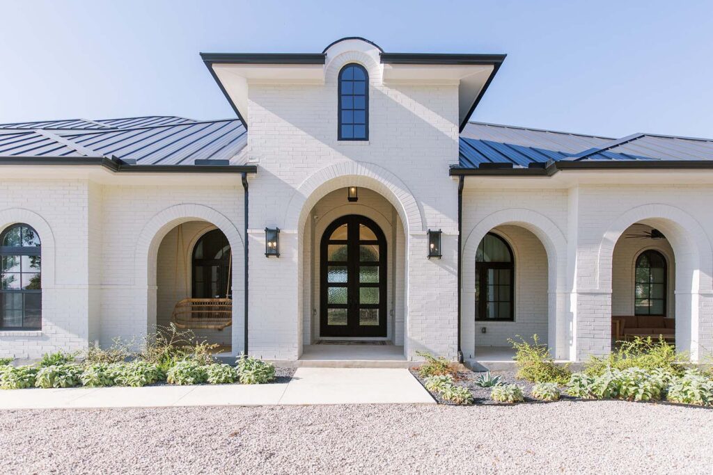 Five Oaks Custom Builder building luxury homes in the Austin area - painted brick exterior -