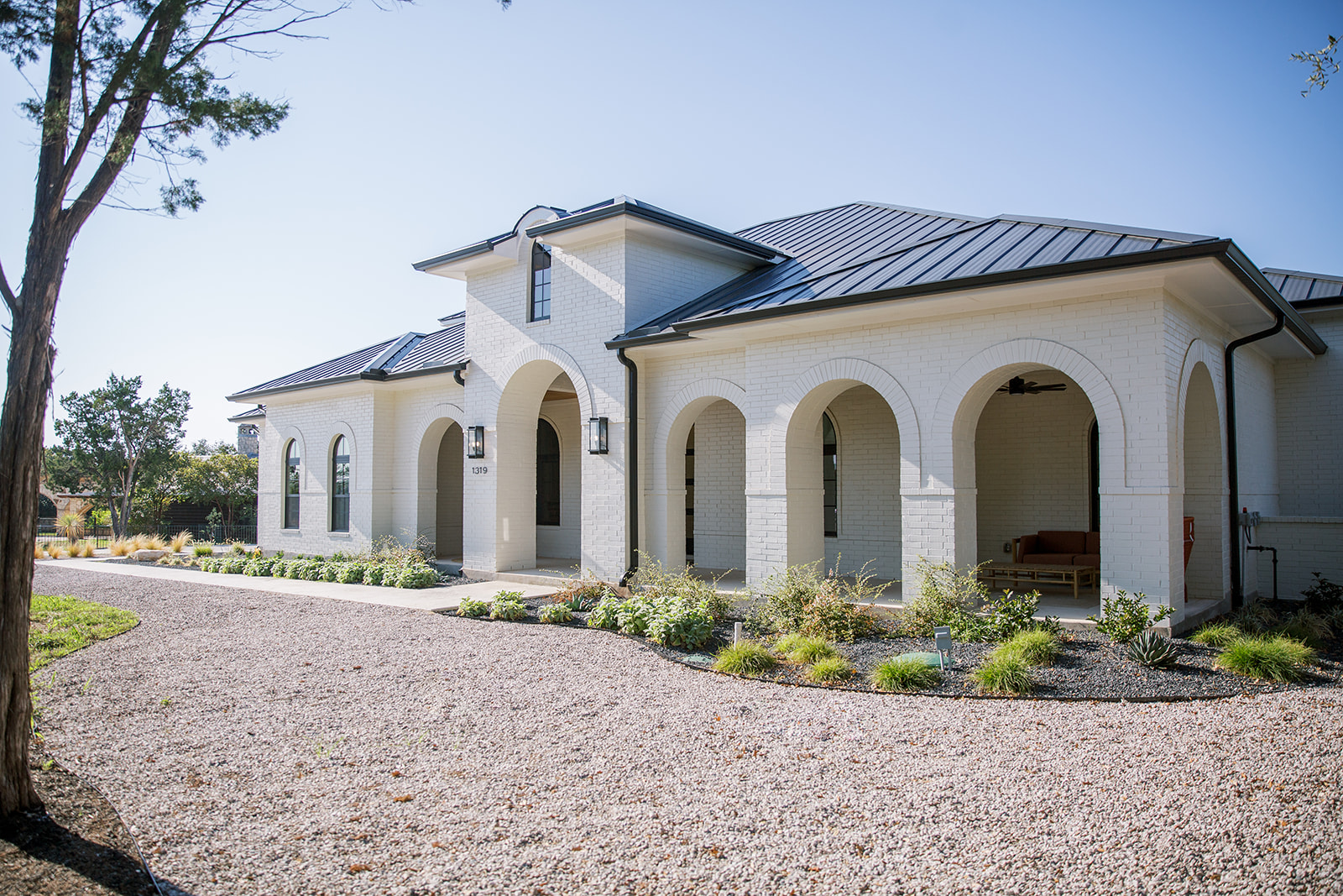 Five Oaks Custom Builder - front porch with arches in Austin, Texas, custom white brick home